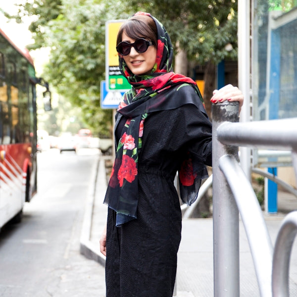 woman wearing hijab standing in front of bus