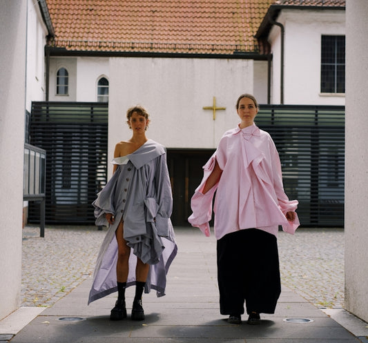 a couple of women walking down a street