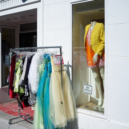 a display of clothes in a window of a clothing store